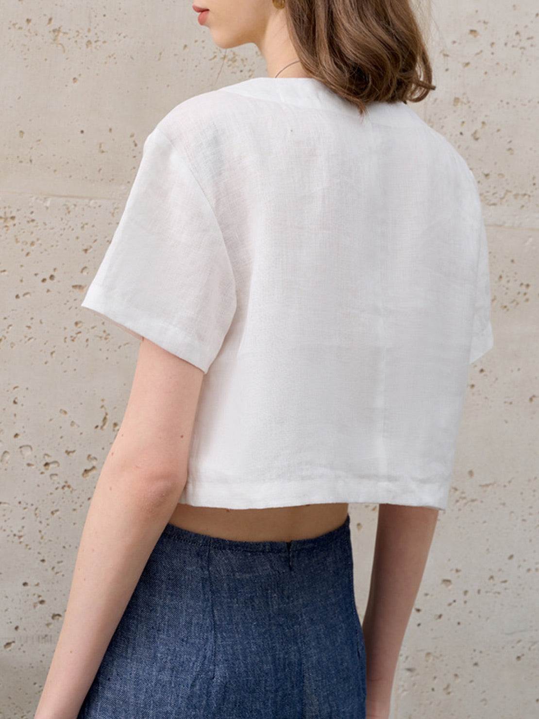 Lightweight 100% linen French top with V-neck, three-button front, short sleeves, and relaxed boxy shape in light khaki and off white