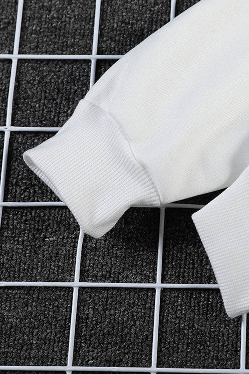 Close-up of white ribbed cuff on oversized graffiti rose hoodie sleeve on black grid background