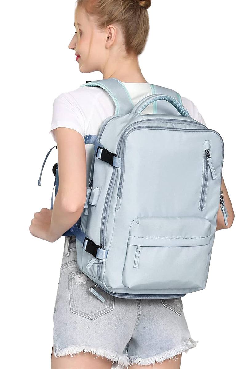Chic Wanderlust Waterproof Backpack in light blue worn by woman, featuring multiple compartments and ergonomic straps