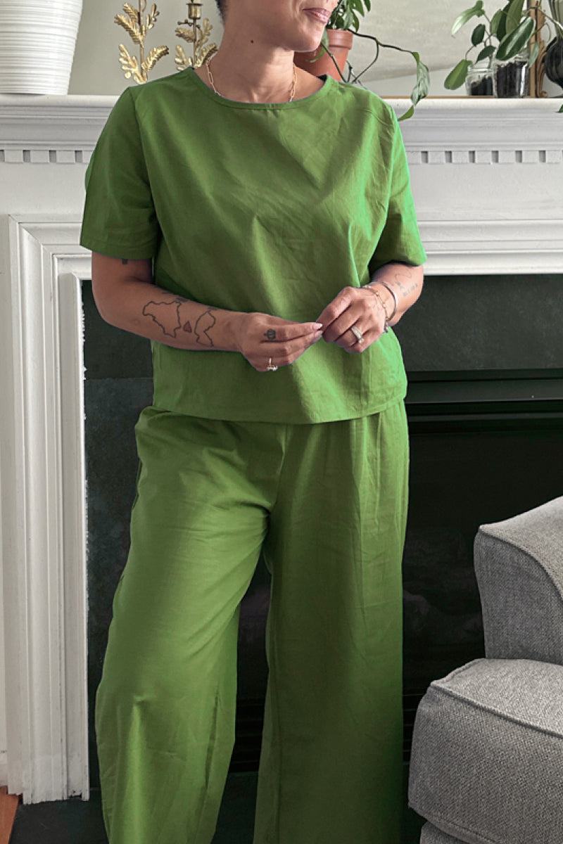 Woman wearing green loose fit co-ord set with short-sleeve top and wide-leg pants in a relaxed style