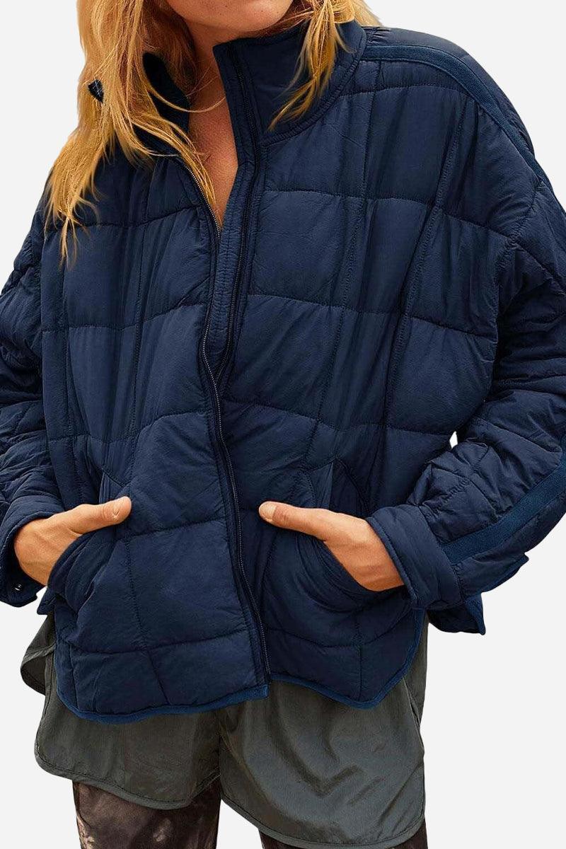 Lightweight puffer travel jacket packed compactly for travel and styled for versatility and warmth