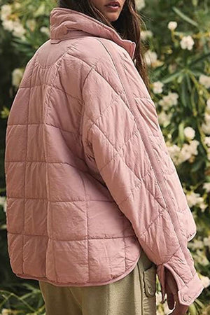 Lightweight pink puffer travel jacket for women, packable and warm, perfect for casual outdoor wear.