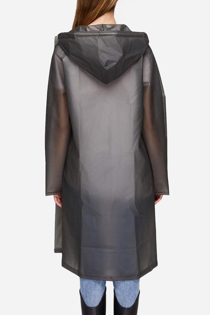 Back view of Chic Drizzle Defender lightweight translucent raincoat with hood worn over casual jeans