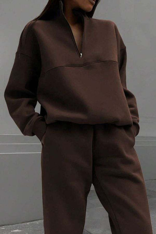 woman wearing brown cotton-blended two-piece tracksuit with high collar and deep zipper