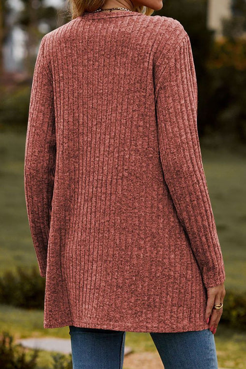 woman wearing a long lightweight ultra soft knit-like cardigan in dusty rose color, back view