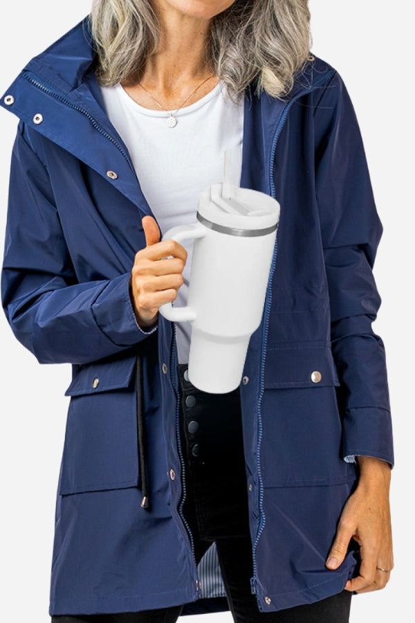 Woman holding white stainless steel indestructible travel cup with handle and spill-proof lid