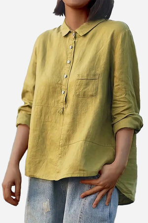 Vintage linen shirt in light olive with button front and chest pocket, styled casually with rolled sleeves and denim jeans.