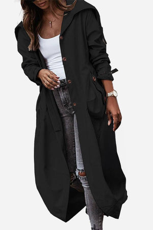 Black minimalist hooded coat with oversized fit, button front, and pockets worn over casual outfit
