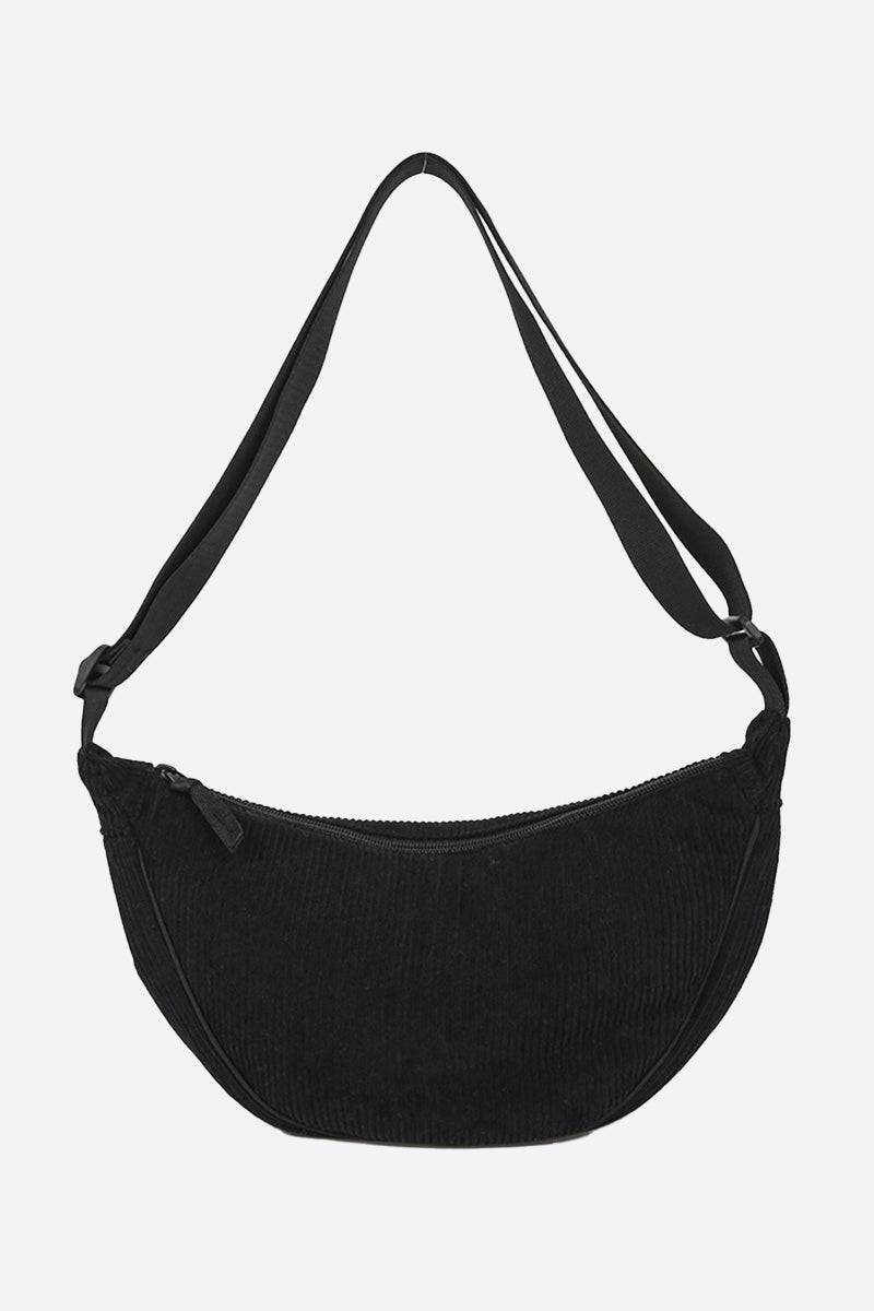 Black corduroy shoulder bag with adjustable strap and zip closure, lightweight and spacious design.