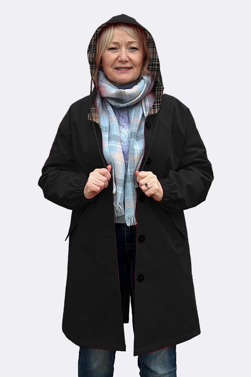 Travel-Smart Waterproof Hooded Windbreaker in black with plaid lining and adjustable hood worn by woman