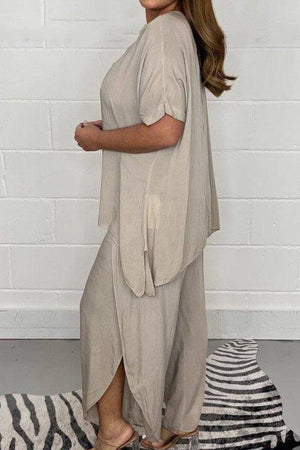 Relaxed linen-like travel two-piece set in beige with loose fit and side slits worn by woman