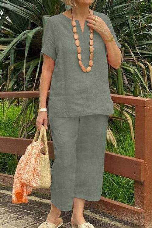 Woman wearing breezy cotton blend short-sleeve top and elastic waist pants summer set outdoors