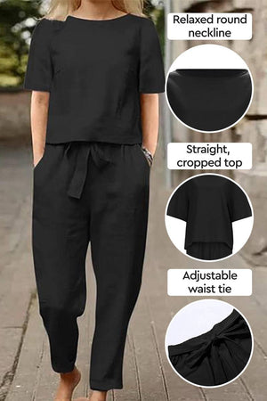 Black cotton-linen blend two-piece set with relaxed round neckline, cropped top, and adjustable waist tie.