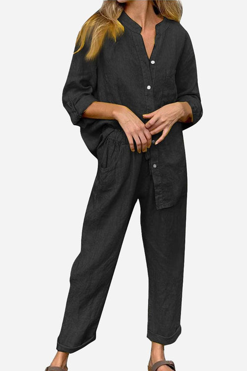 Woman wearing black casual chic two-piece set with long sleeves and relaxed fit pants