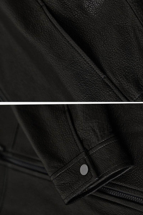 Close-up of black sheepskin leather jacket texture and sleeve detail with snap button, showcasing genuine soft leather material.