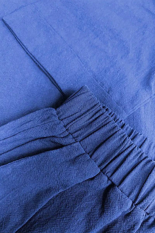 Close-up of a blue 100% cotton two-piece set with elastic waistband and textured fabric
