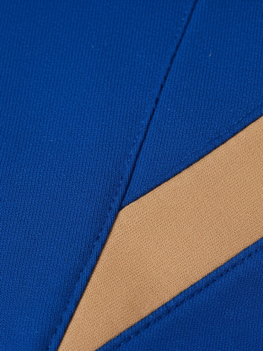 Woman wearing a colorblock comfort tracksuit with contrast curved panels and relaxed fit for casual wear