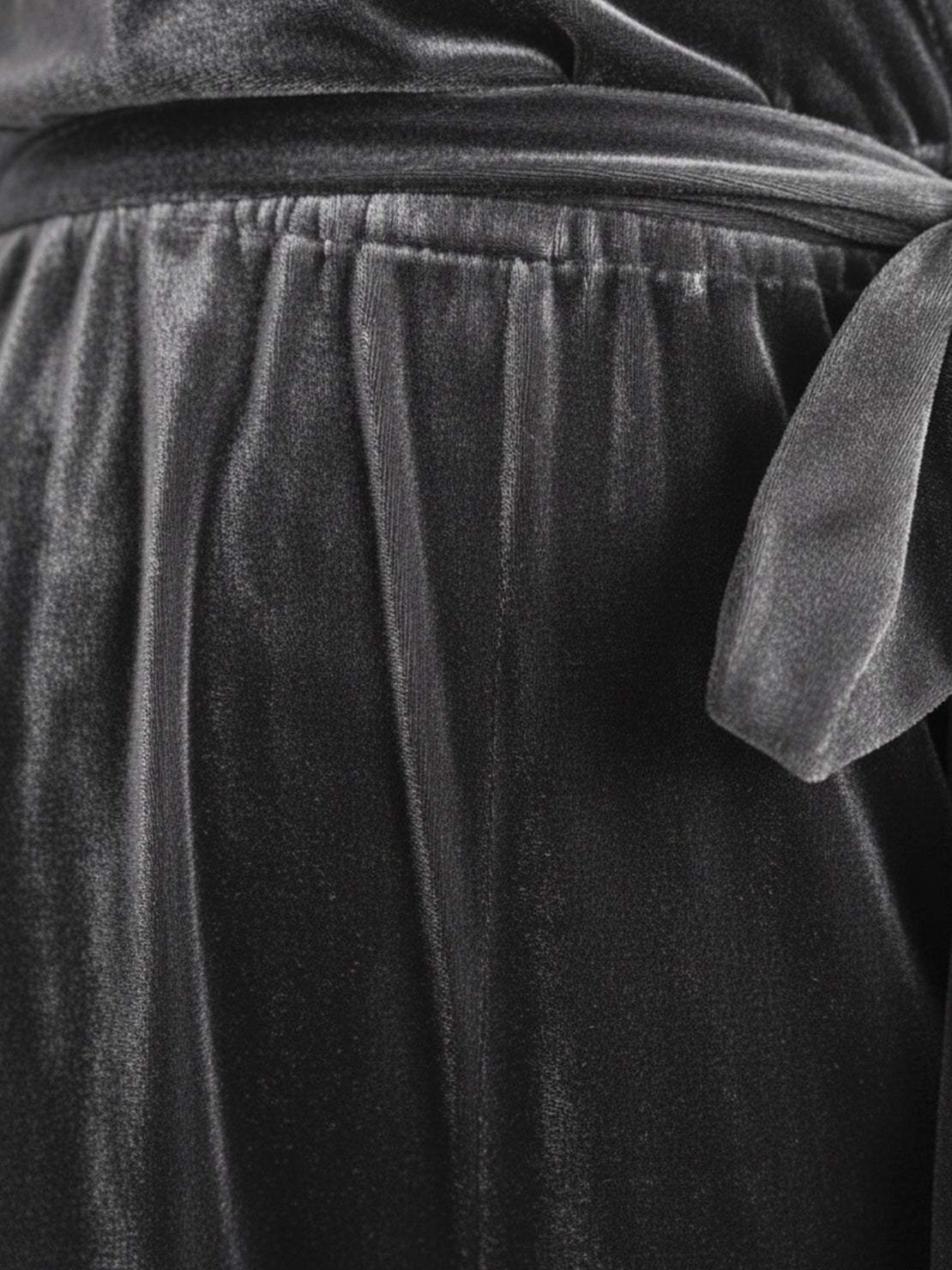 Woman wearing deep V-neck velvet suit with long sleeves and wide-leg pants