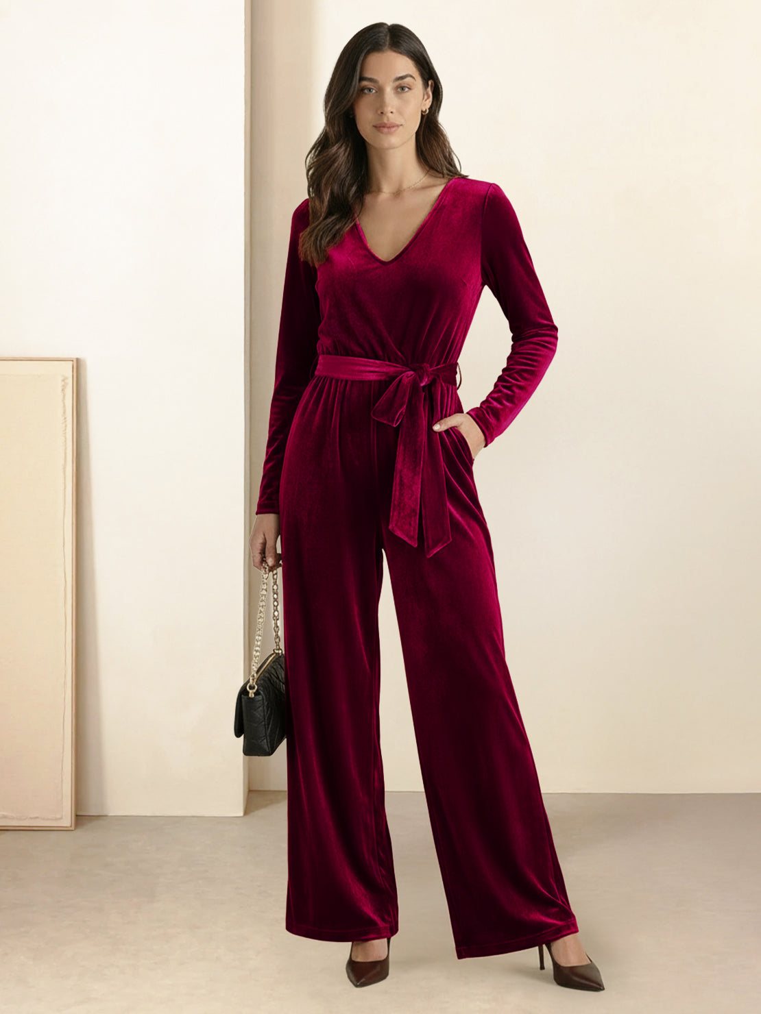 woman wearing deep v-neck velvet suit with long sleeves and wide-leg pants