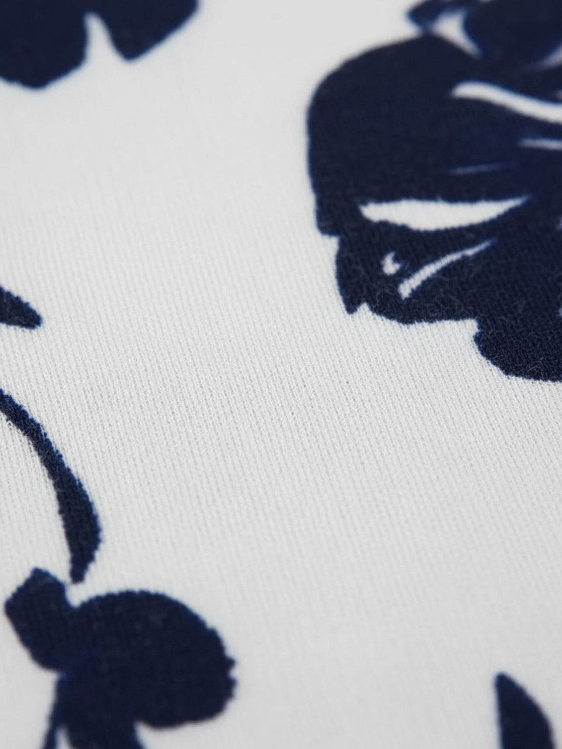 Woman wearing open-front three-piece co-ord with longline cardigan, tank top, and wide-leg trousers in lightweight knit fabric