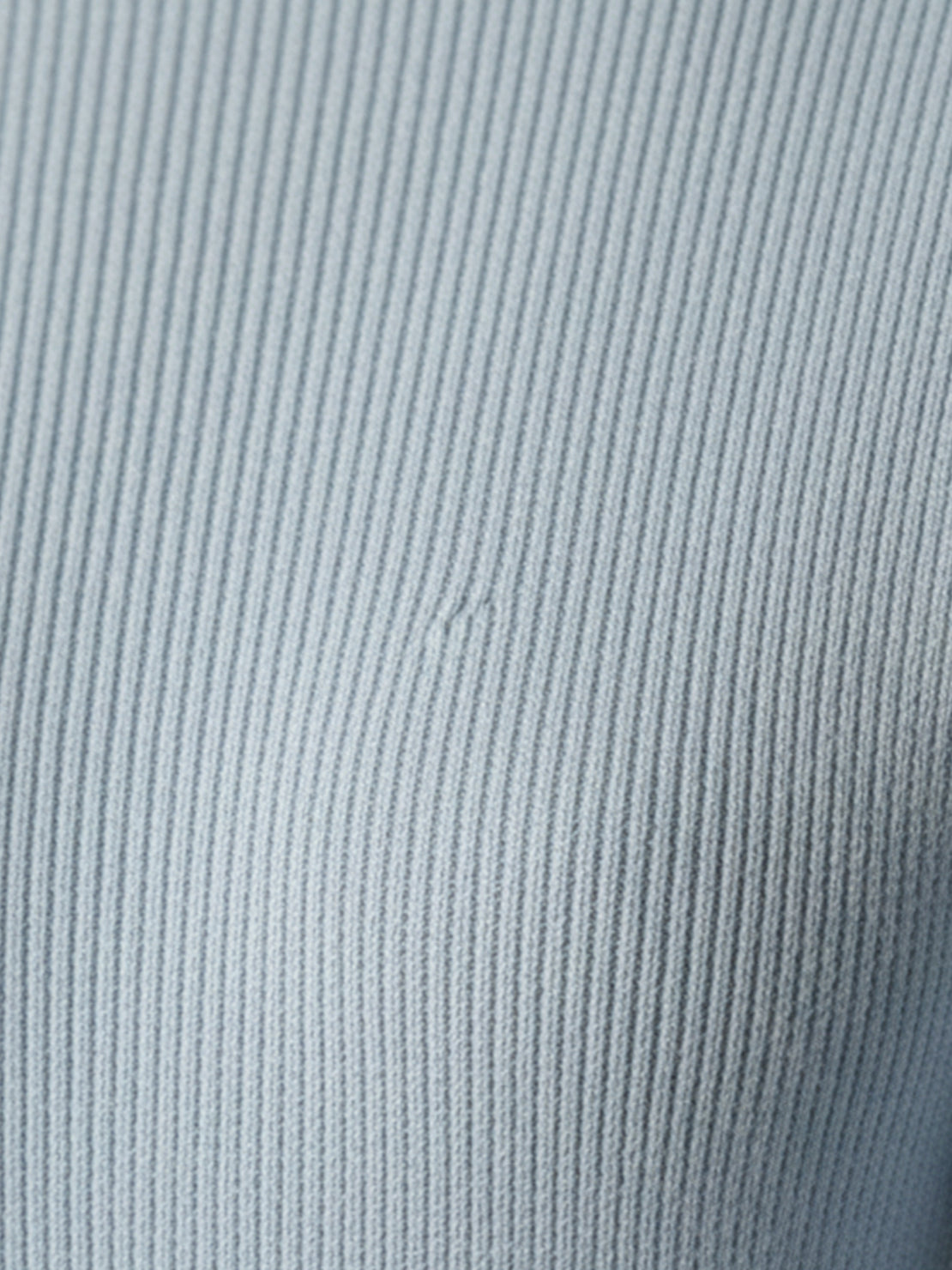 Asymmetric wrap ribbed knit top with diagonal button closure and flared cuffs