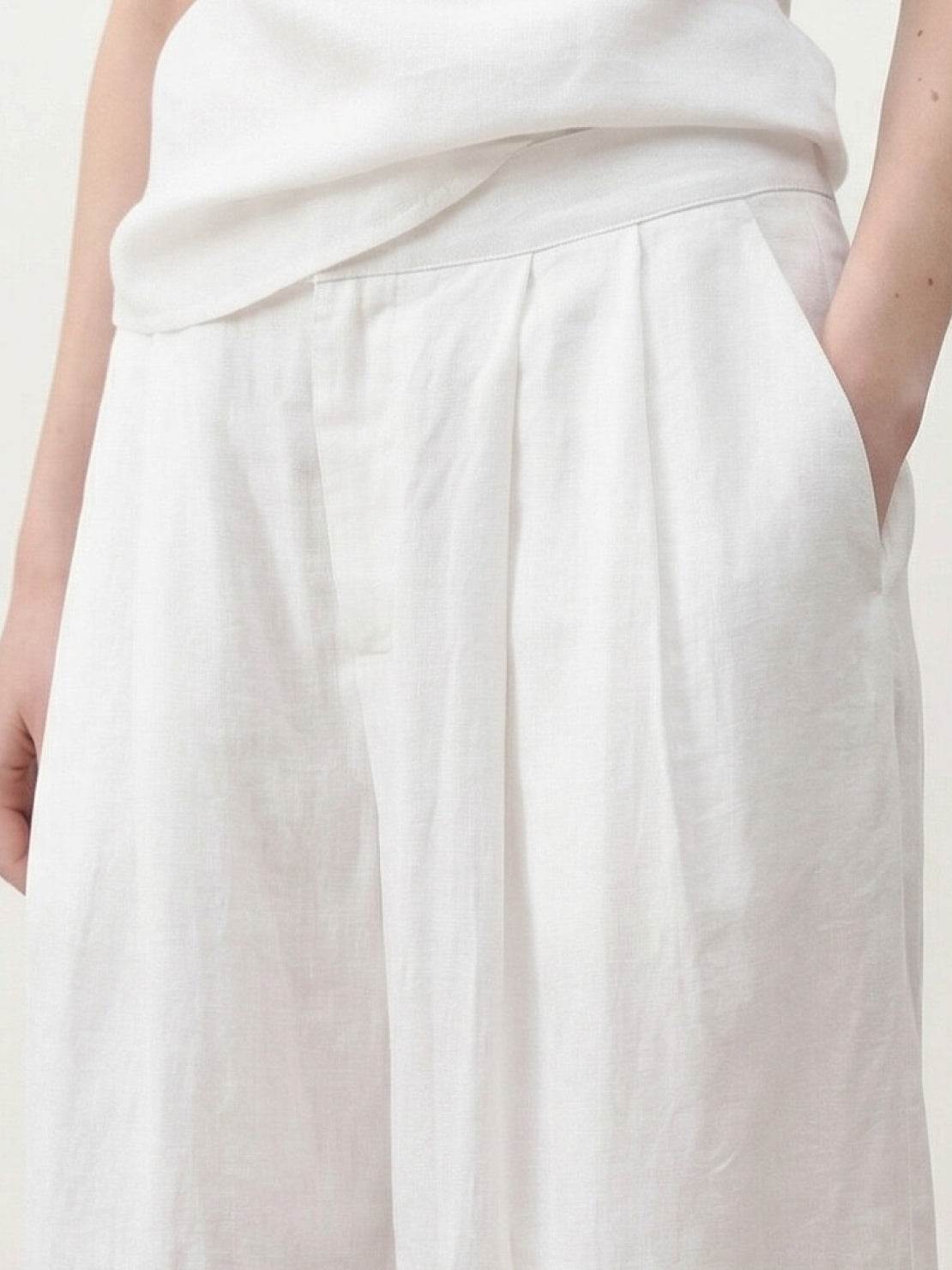 White Tencel-linen pleated wide-leg pants with hook-and-zipper waist closure and floor-length silhouette