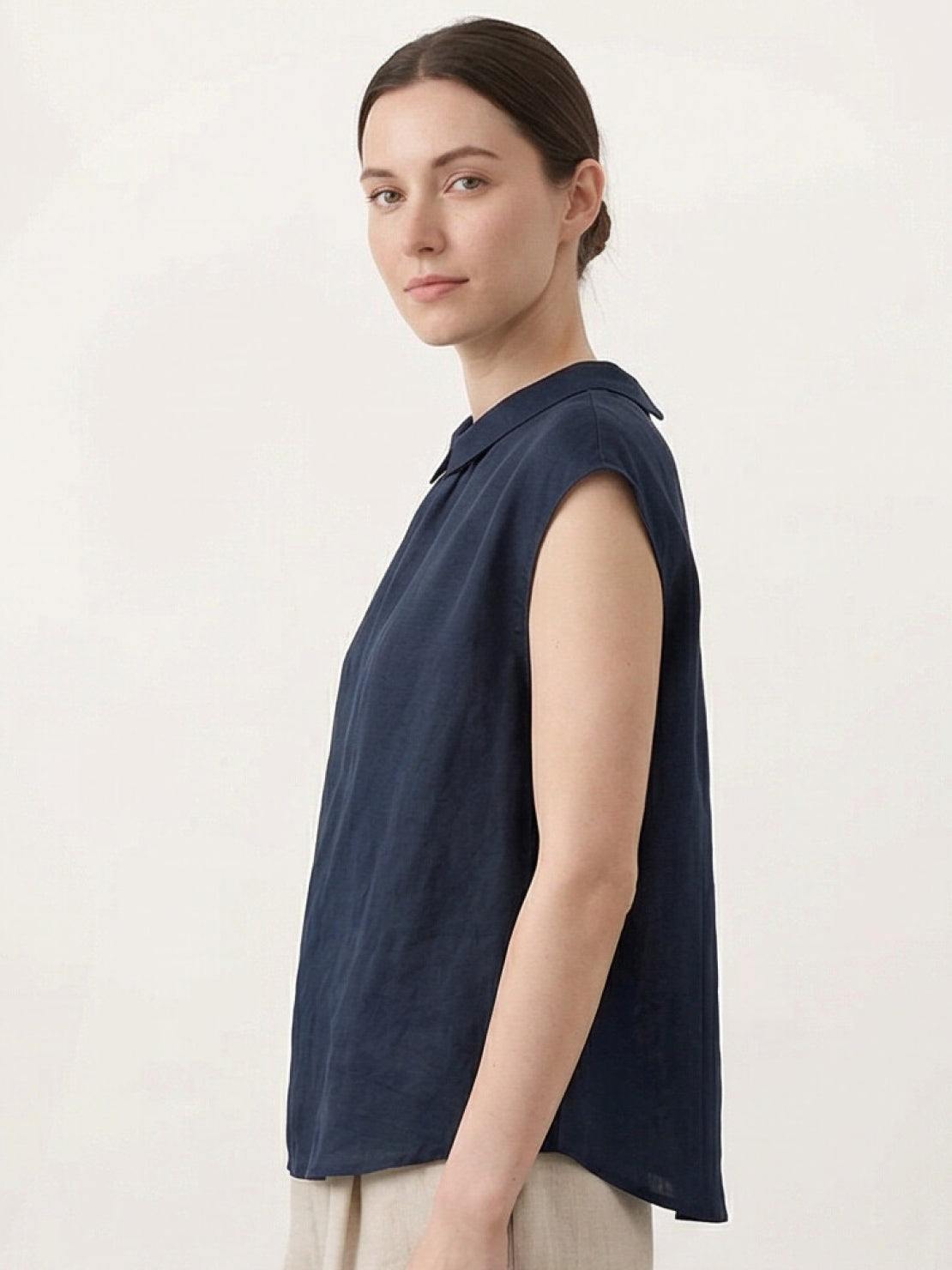 100% linen two-way button blouse with rounded Peter Pan collar and cap sleeves in relaxed A-line silhouette