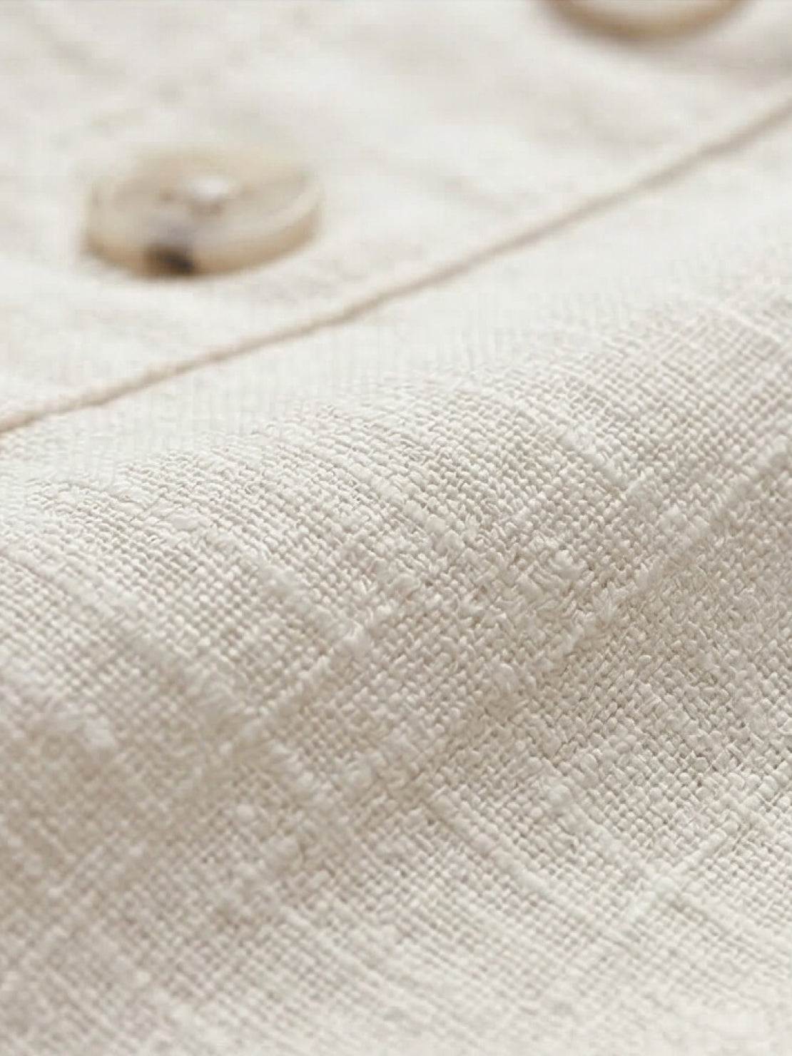 Lightweight 100% cotton linen sleeveless top with relaxed fit, curved hem, side slits, and chest pocket detail