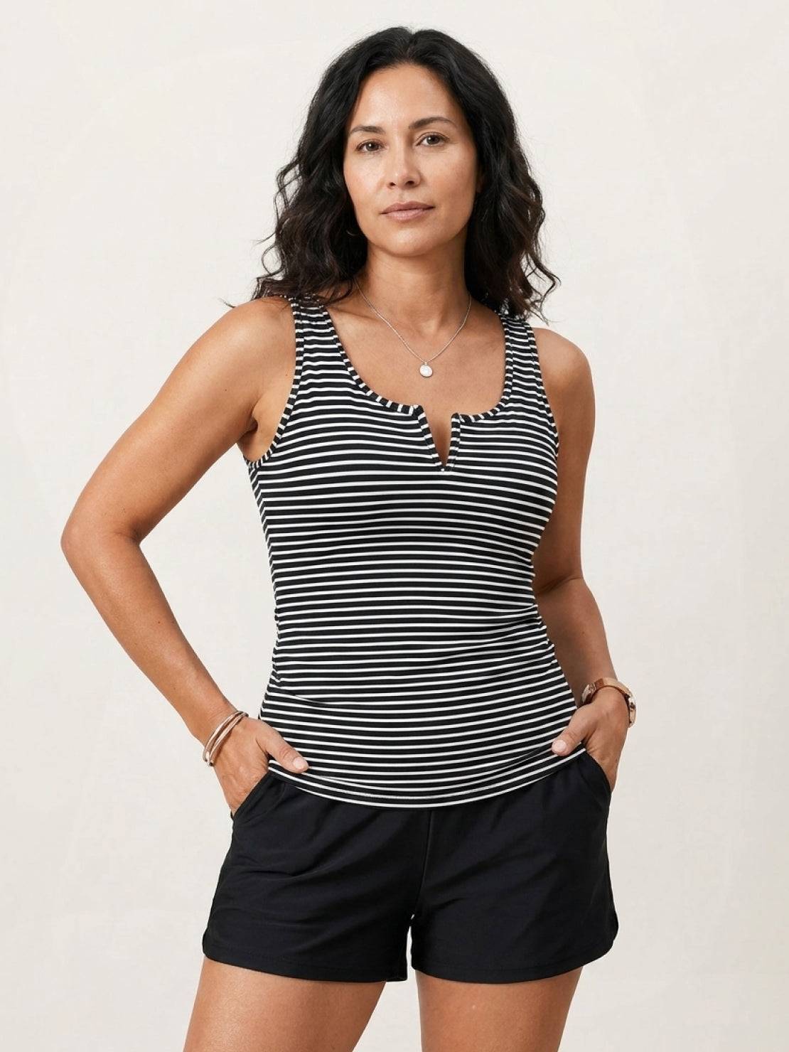 Two-piece V-notch tankini set with adjustable straps and high-waist swim shorts with built-in brief lining.