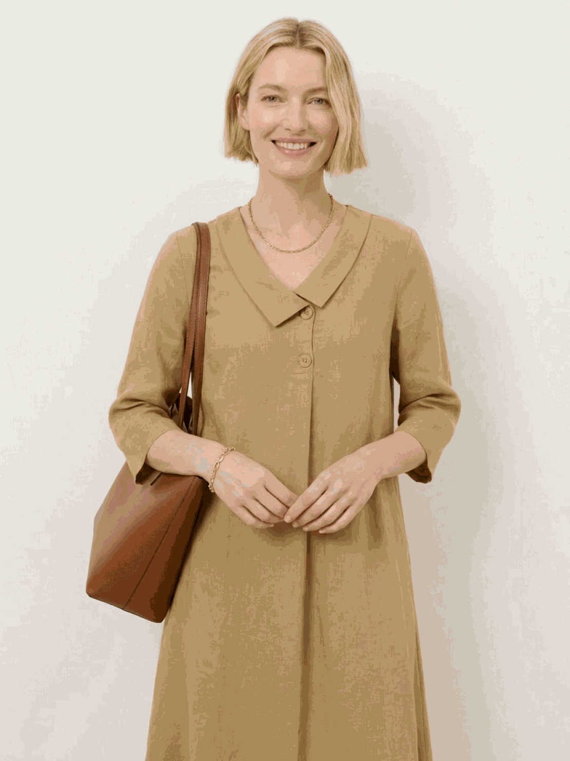 Woman wearing navy linen-look midi dress with blazer neckline and button detail