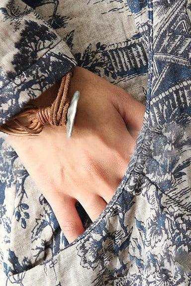 Close-up of hand in pocket on Japanese Porcelain Print Dress with blue and beige pattern
