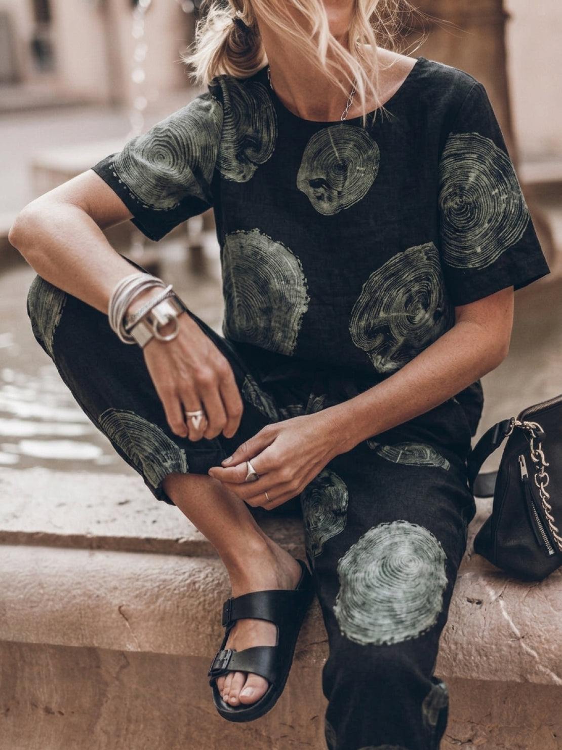Woman wearing relaxed cotton-linen two-piece set with short-sleeve top and straight-leg pants in monochrome