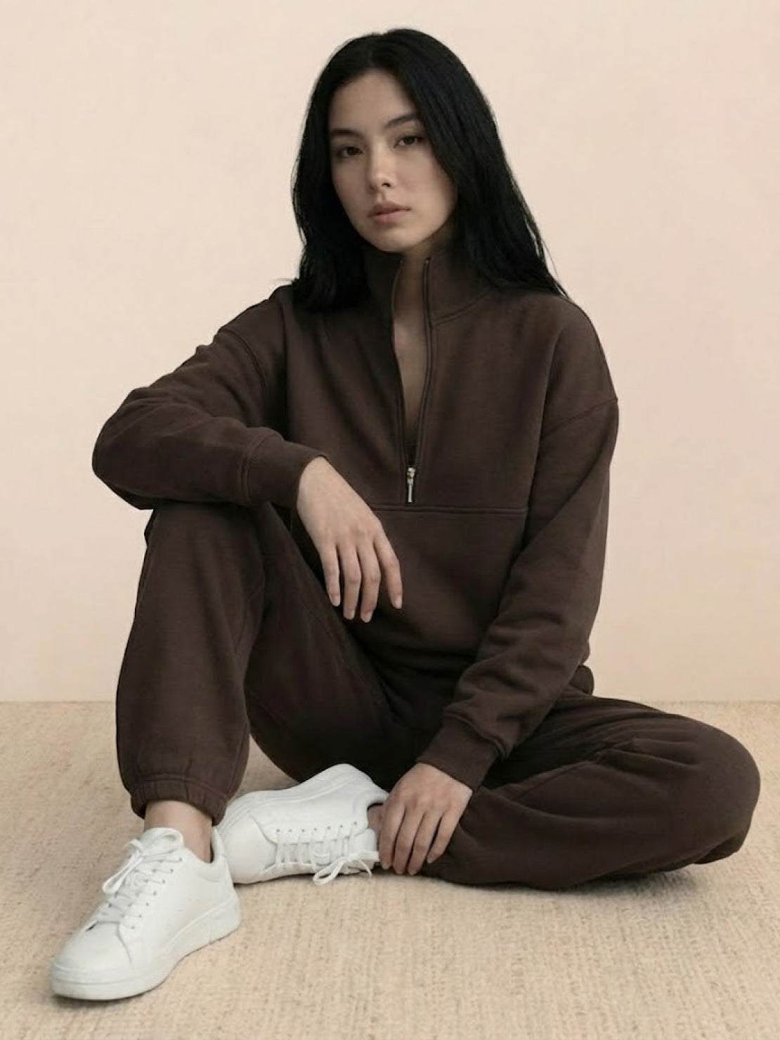 woman wearing cotton-blended two-piece tracksuit with high collar and deep zipper in casual athleisure style