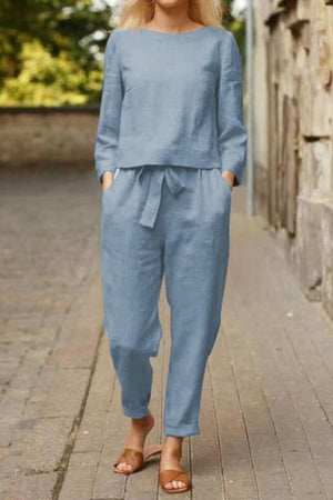 Woman wearing blue cotton-linen monochrome relaxed longline top and wide-leg pants outdoors