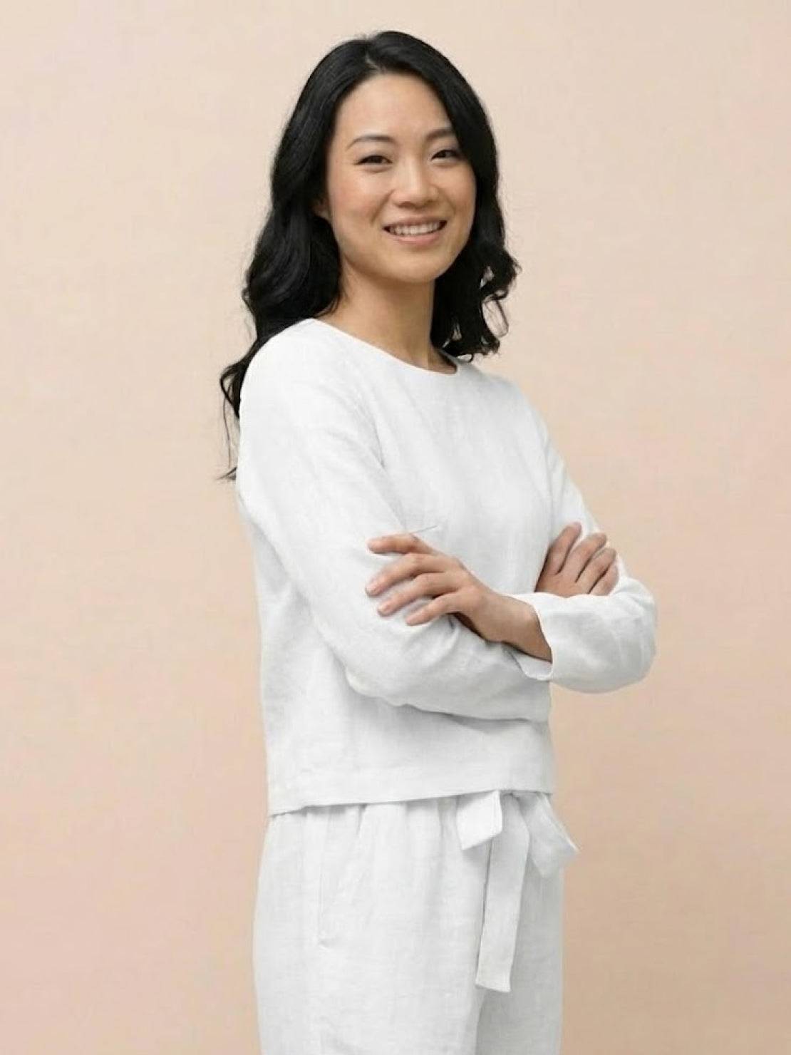 Woman wearing a relaxed cotton-linen monochrome capsule outfit with longline top and wide-leg pants