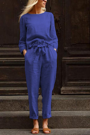 Woman wearing blue cotton-linen monochrome capsule outfit with relaxed longline top and wide-leg pants