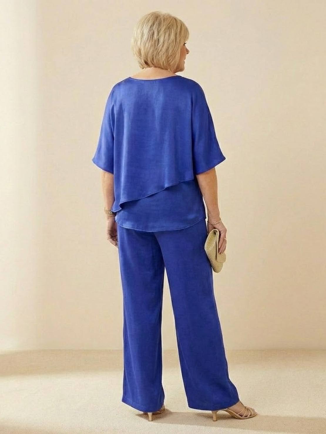 Woman wearing Elegant Layers Two-Piece Set with layered V-neck top and matching pants in light fabric