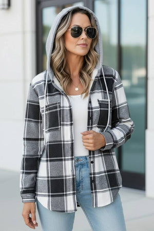 Woman wearing Highland Plaid Shacket with gray hood and black white plaid pattern