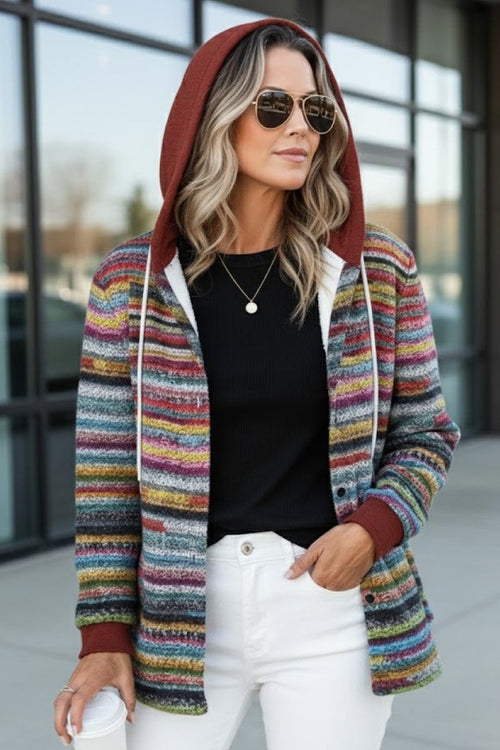 Woman wearing Highland Plaid Shacket with hood, colorful striped plaid pattern, soft fleece lining, and relaxed fit outdoors