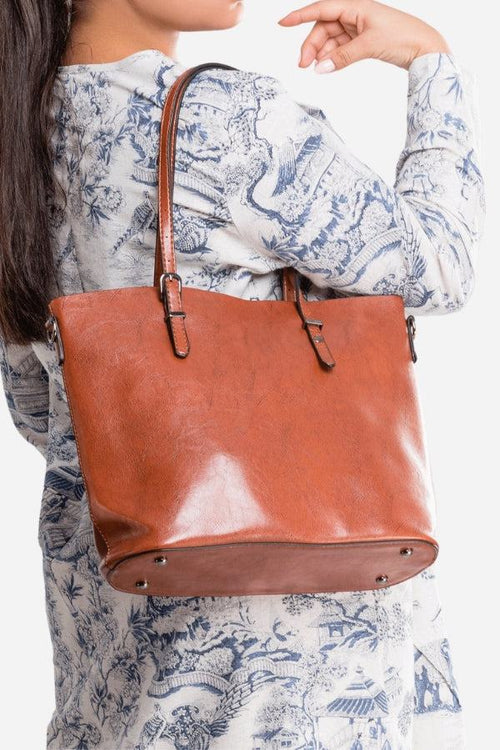Brown PU leather multi strap tote shopper bag worn on shoulder with buckle details and spacious interior