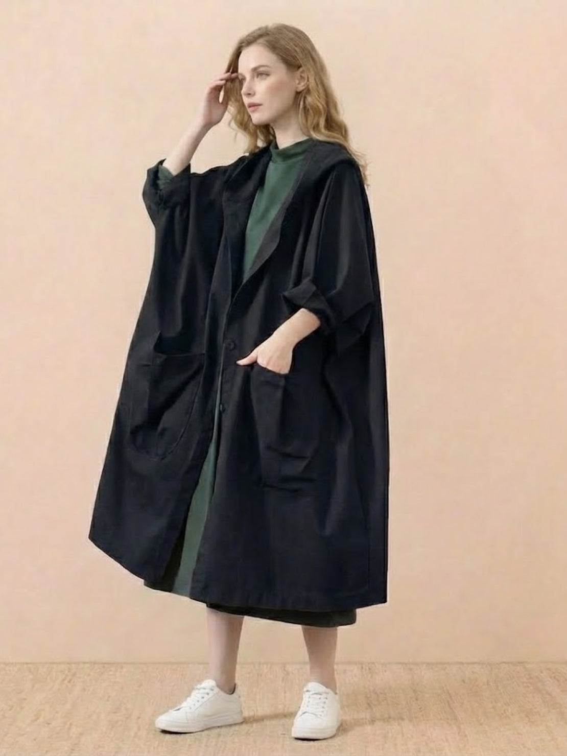 One size oversized black waterproof windbreaker jacket with hood and large pockets worn by woman