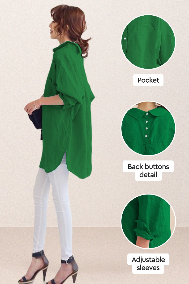 Woman wearing oversized green linen shirt with back button detail, adjustable sleeves, and side pocket.