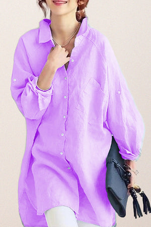 Woman wearing oversized linen shirt in light purple with loose sleeves and button-down front