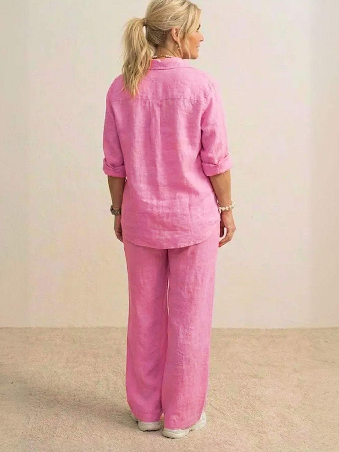 Woman wearing oversized 100% cotton pink shirt and wide-leg pants co-ord set, back view