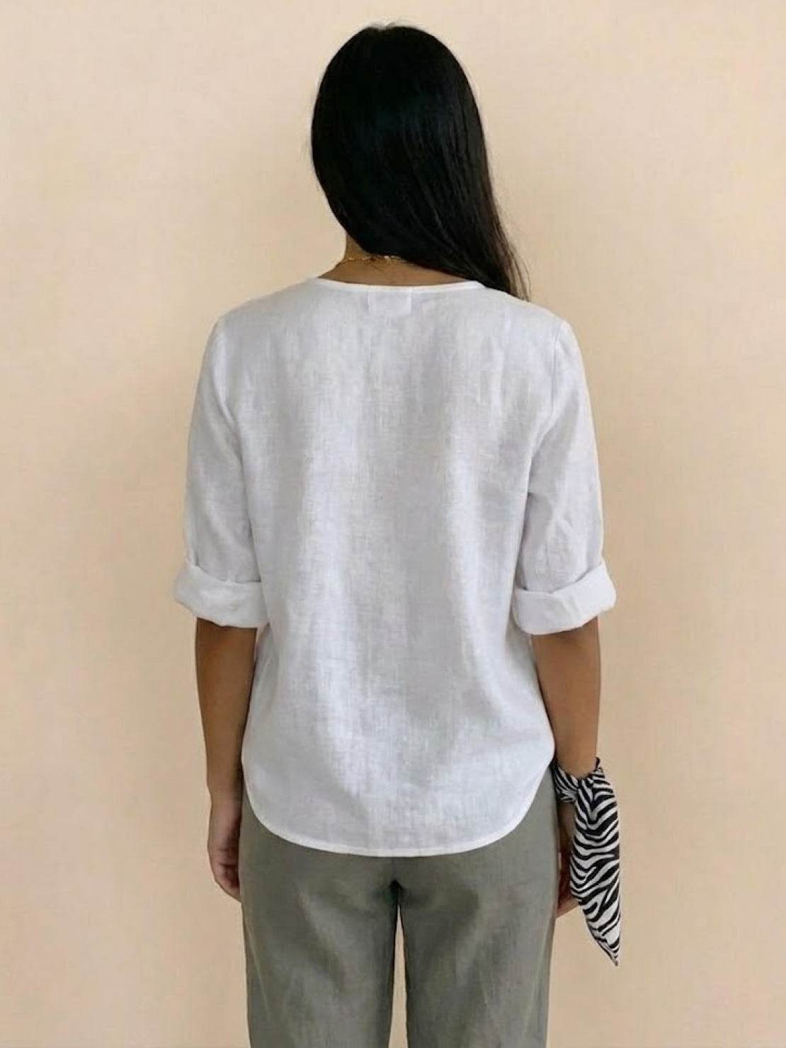 Woman wearing Pure Linen Age-Defying Shirt with button detail in white, breathable and elegant summer top
