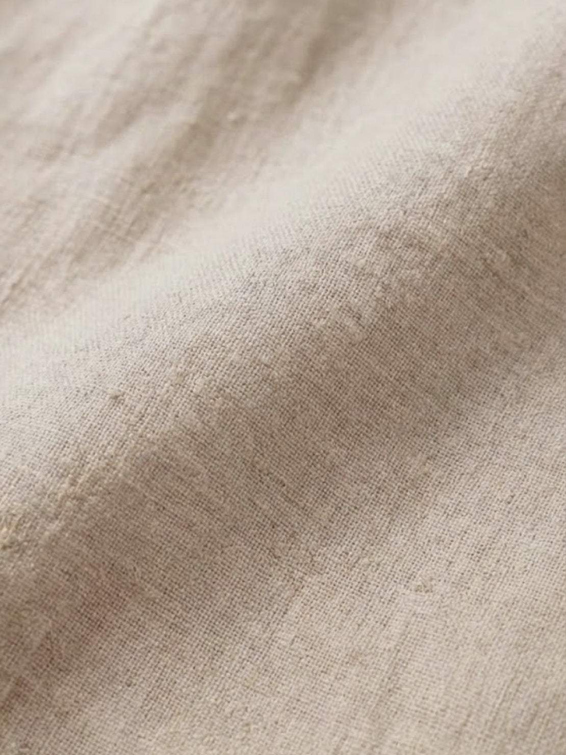 white pure linen age-defying shirt with button details on hanger