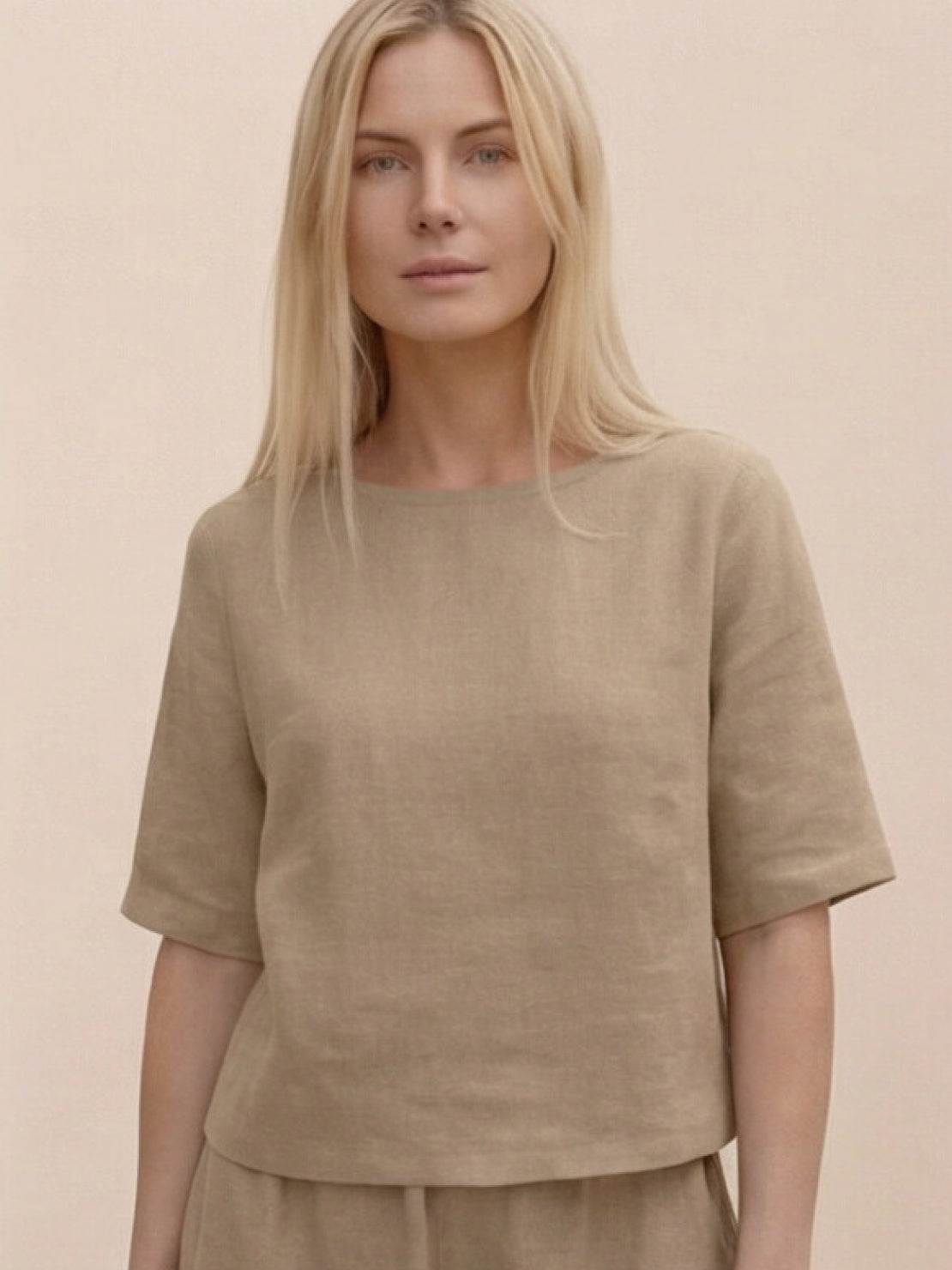 Woman wearing a soft-tailored, wide-sleeve top with wide-leg pants in a loose fit co-ord set