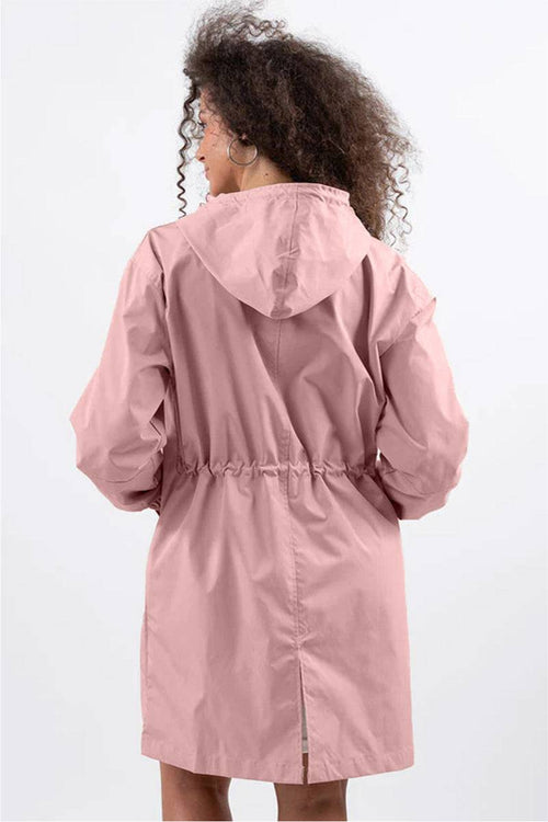 Back view of a woman wearing a pink Rain Couture Windbreaker with an oversized fit and adjustable hood.