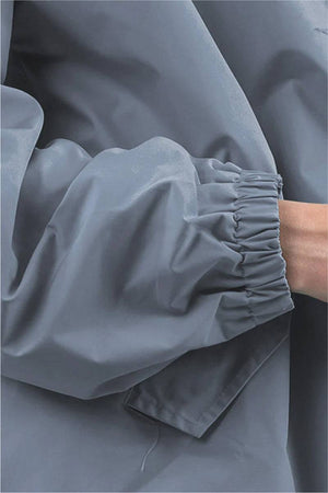 Close-up of Rain Couture Windbreaker sleeve in water-resistant grey fabric with elastic cuff detail
