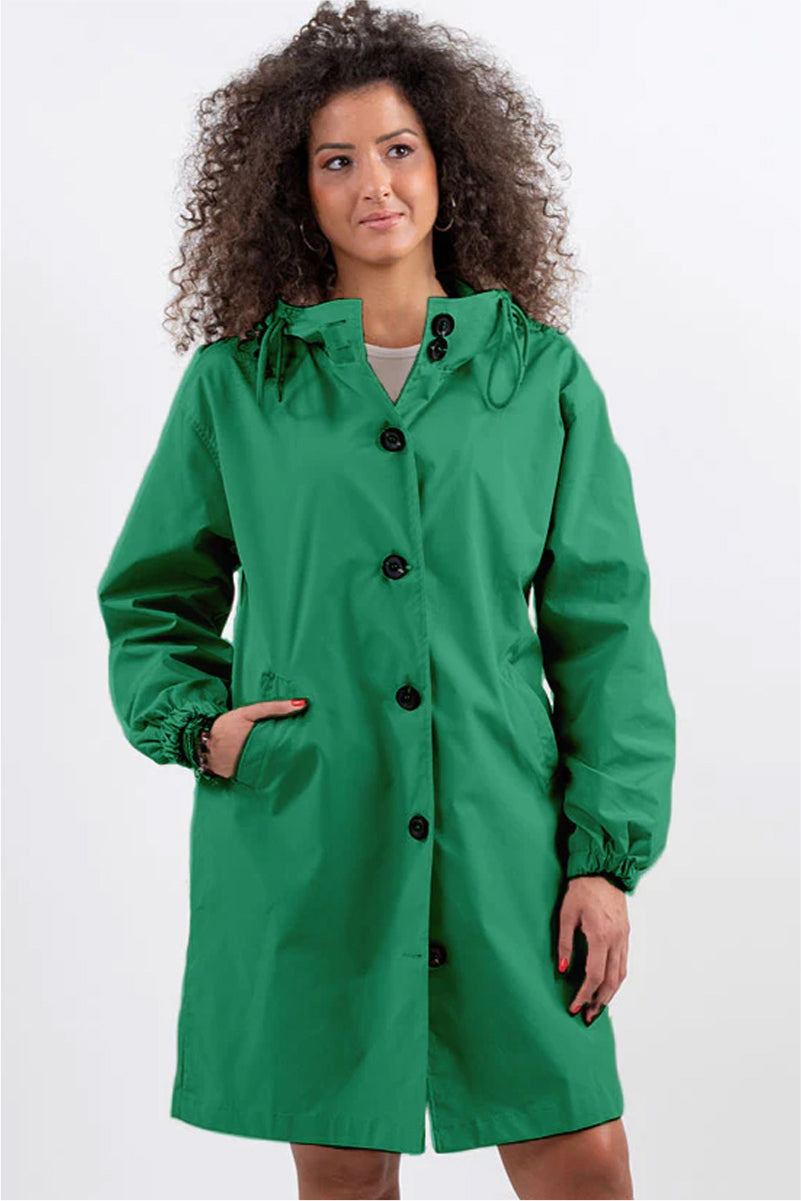 Green oversized Rain Couture Windbreaker jacket with hood and button closure on model